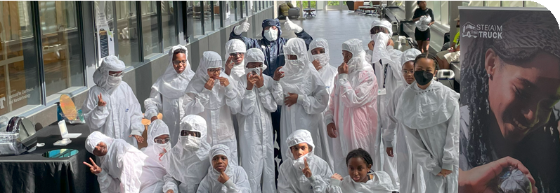 Students in Clean Room Gear outside lab