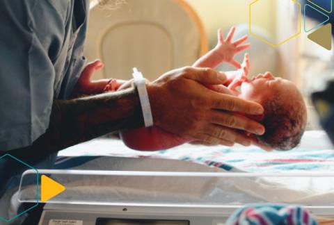 nurse holding new born